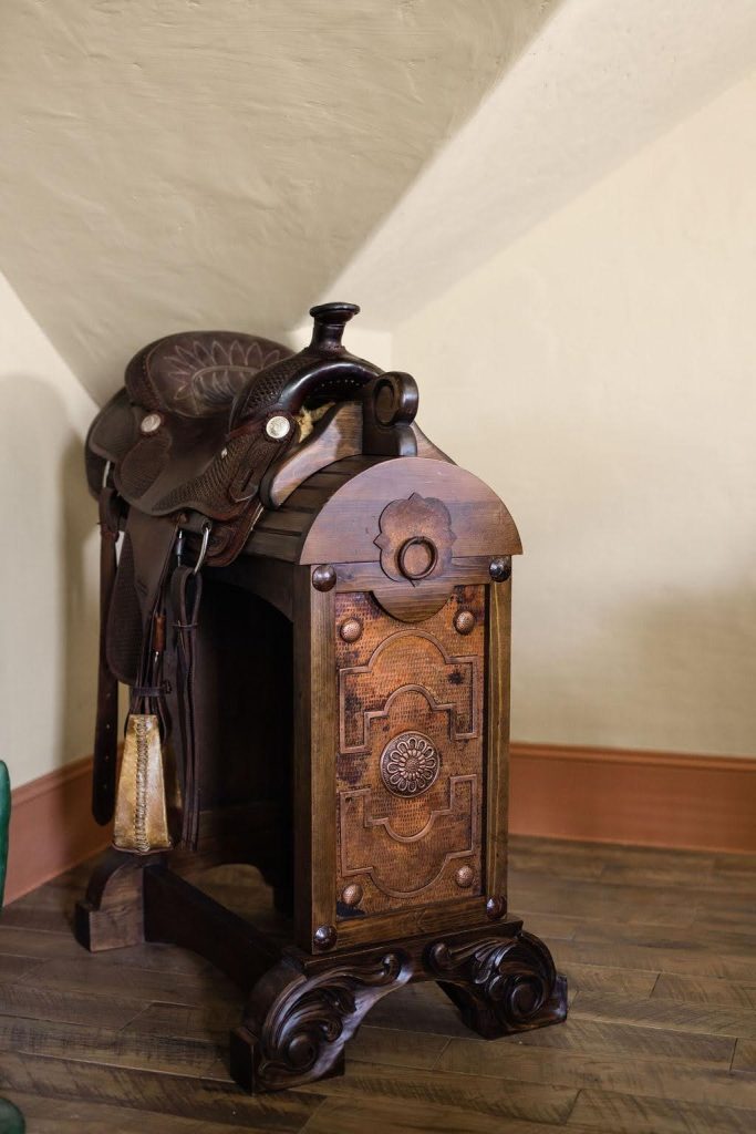 Antique saddle displayed in Hill Country Ranch home