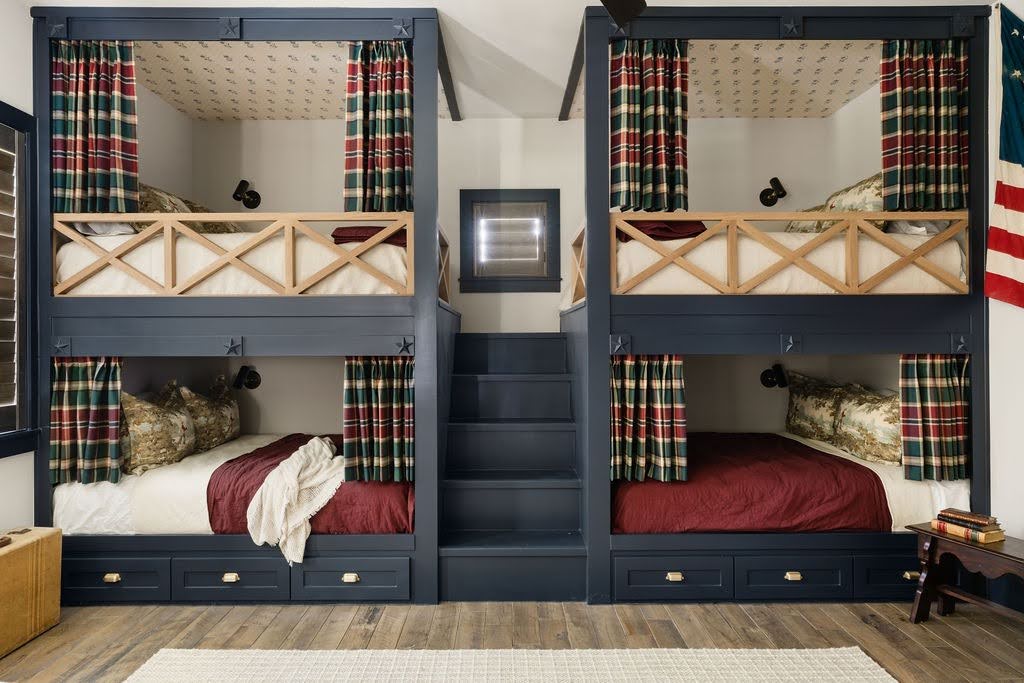 Custom home guest bunk room with built-in beds, plaid curtains, and coordinated bedding